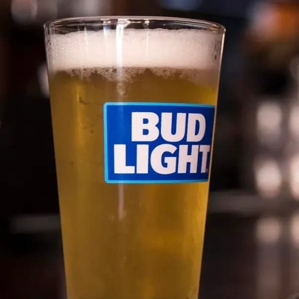A glass of Bud Light beer with a foamy head, ready to be served at Riley's Place.