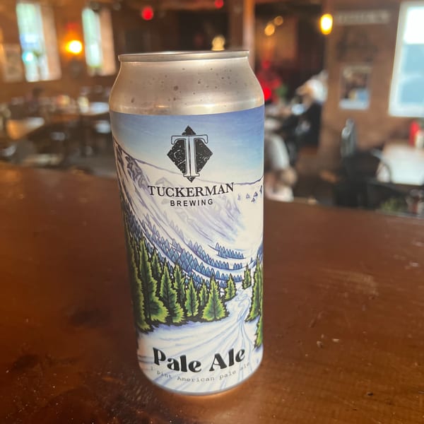 A can of Tuckerman Brewing Pale Ale sits on a wooden bar inside Riley's Place restaurant.