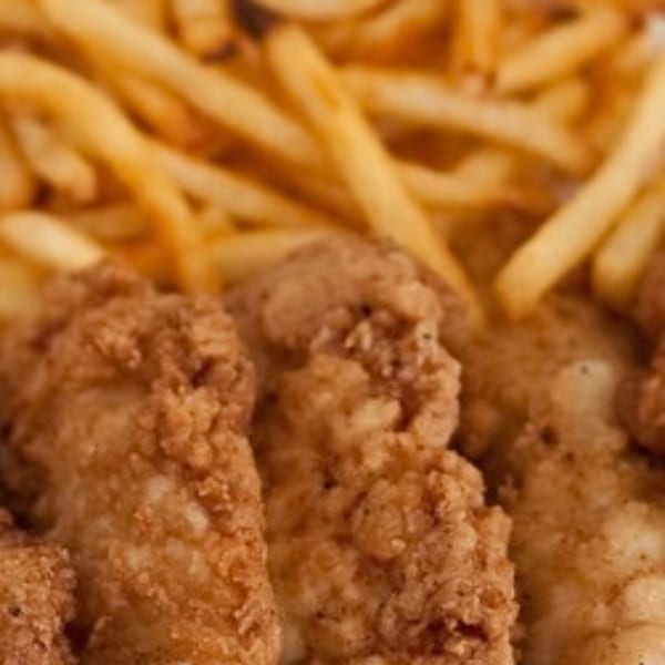 Crispy fried chicken tenders and golden french fries from Riley's Place, an American restaurant.